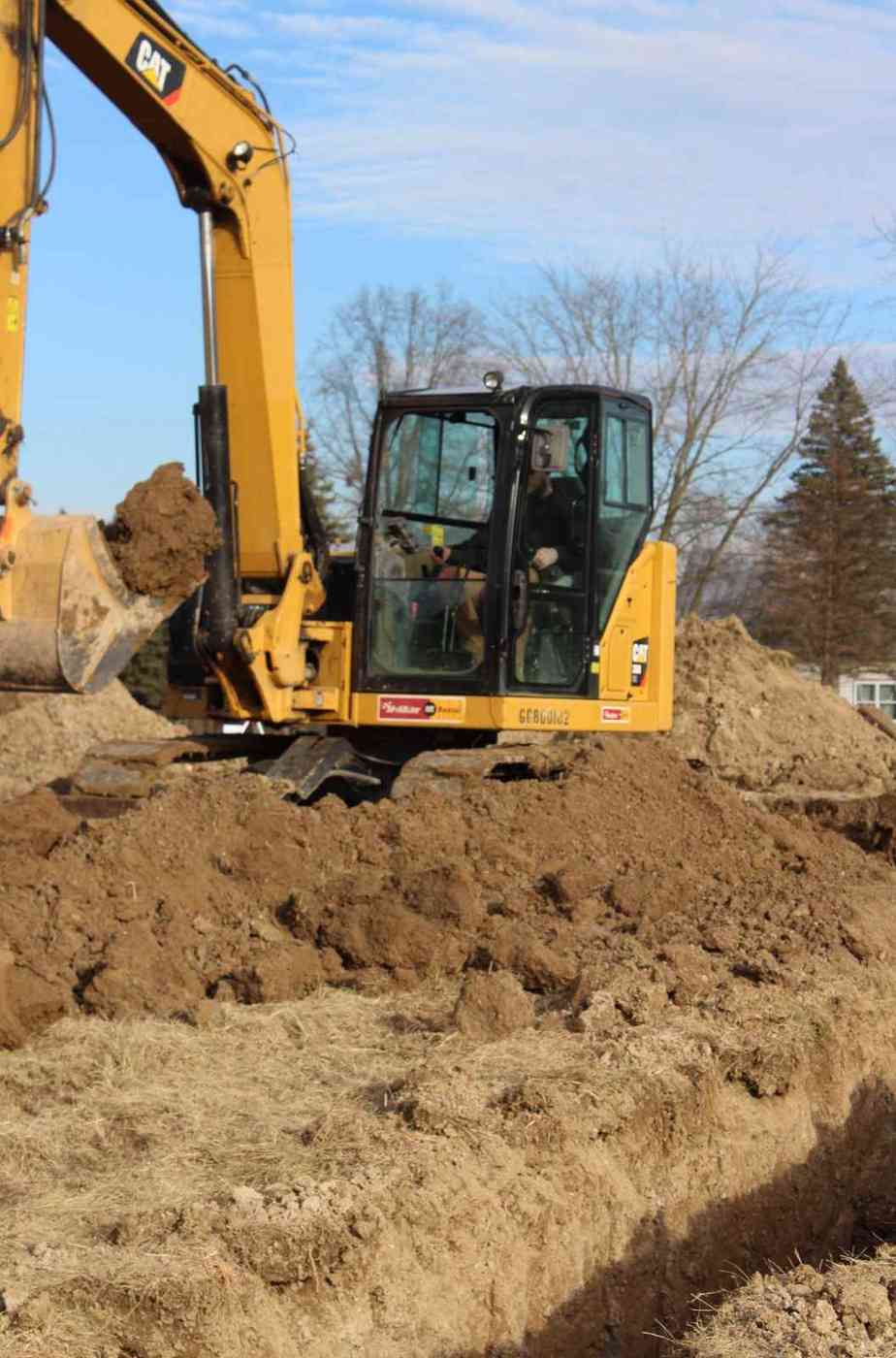 The Foundation Repair Process: What To Expect 2 Excavator digging a foundation trench for a new home